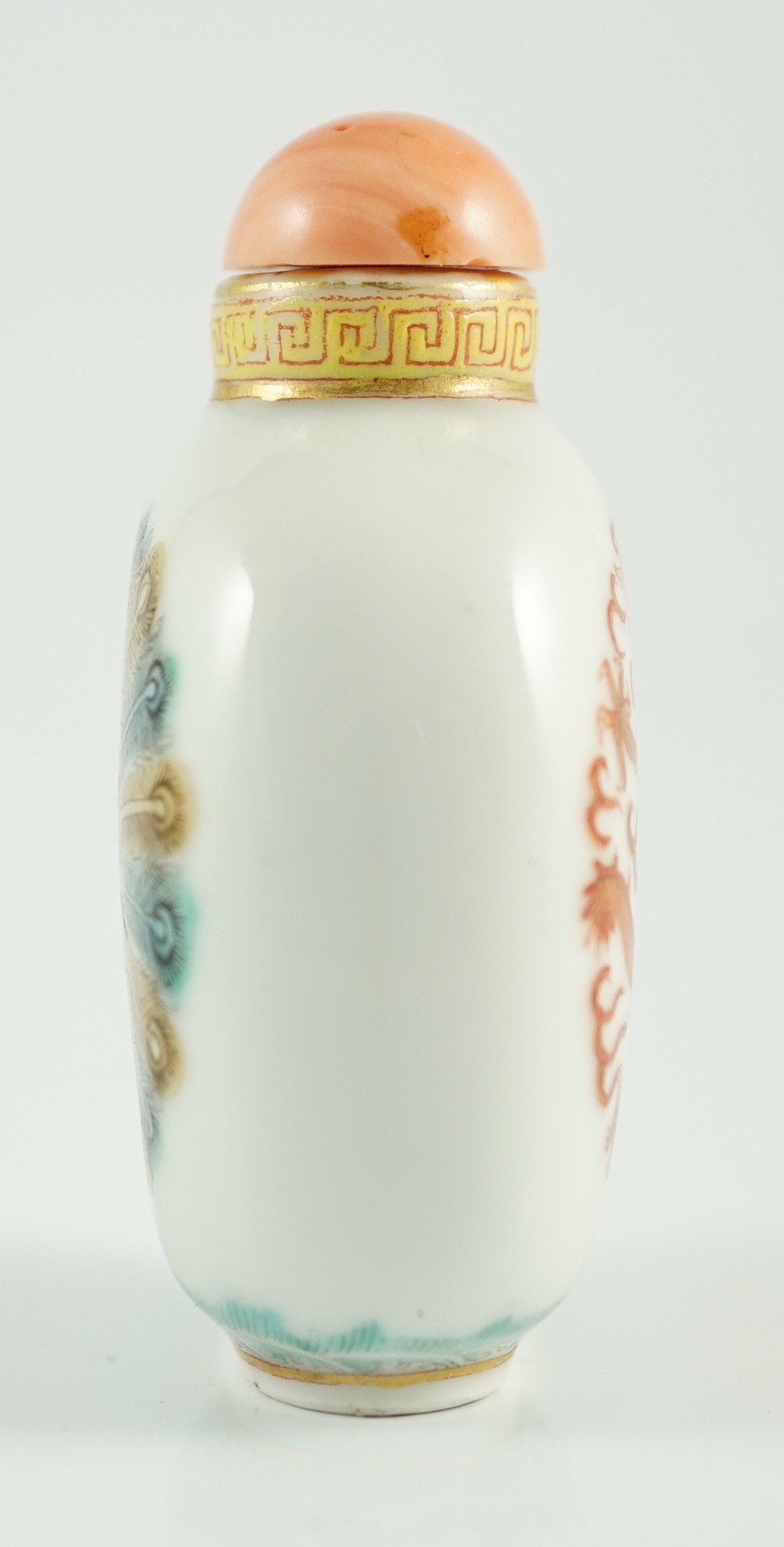 A Chinese enamelled porcelain ‘peacock and dragon’ snuff bottle, Jiaqing mark and period (1796-1820), 5.6cm high, coral stopper and wood stand